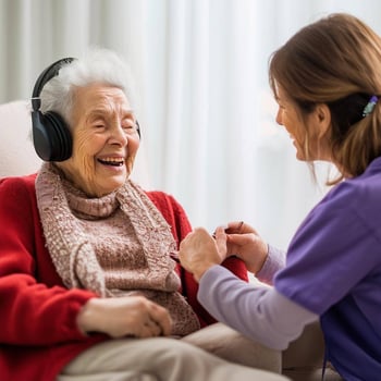Show a woman resident who has dementia but is clearly happy because they are listening to soothing music while having her nails done by a dementia car